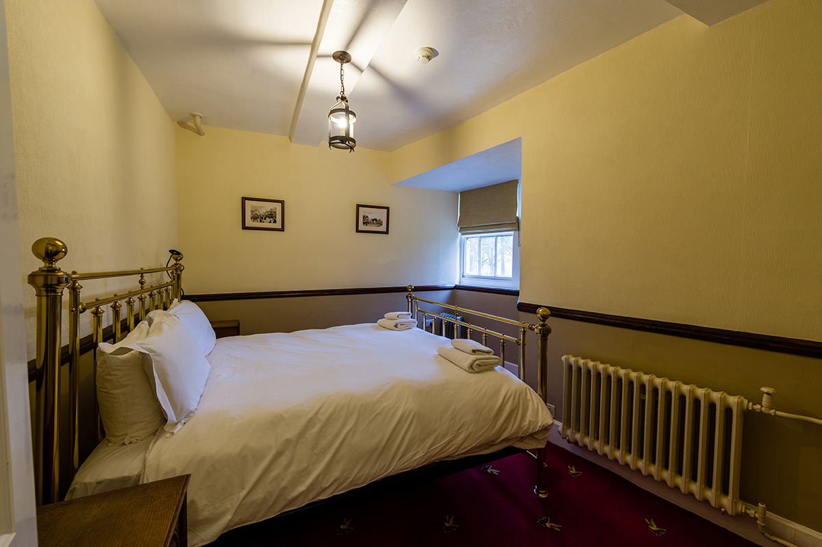 Large brass bed in the Le Meshin bedroom at Appleby Castle in Cumbria