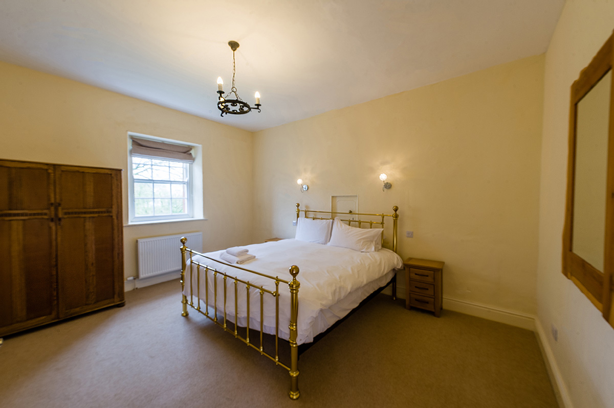 Large brass bed in the self-contained holiday accommodation in Cumbria