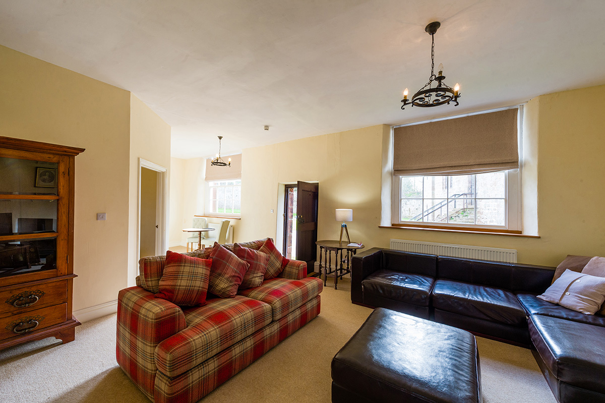 Large comfortable sofas in the lounge in the l self-contained holiday cottages at Appleby Castle